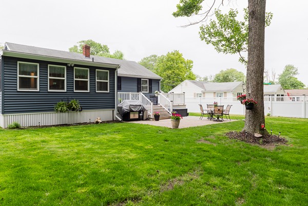 22 Roseen Road Holbrook, MA 02343 - Photo 5 of 30 a front view of a house with a garden and yard