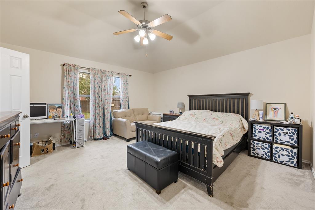 8613 King Ranch Drive Cross Roads, TX 76227 - Photo 14 of 25 a spacious bedroom with a bed and a chandelier