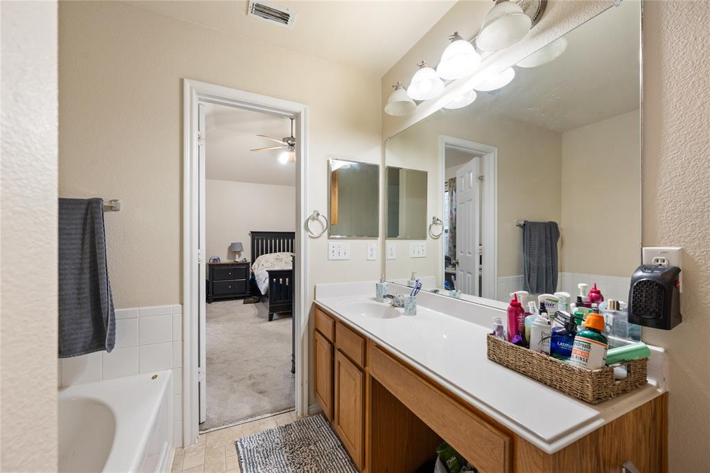8613 King Ranch Drive Cross Roads, TX 76227 - Photo 17 of 25 a bathroom with a sink vanity and a mirror