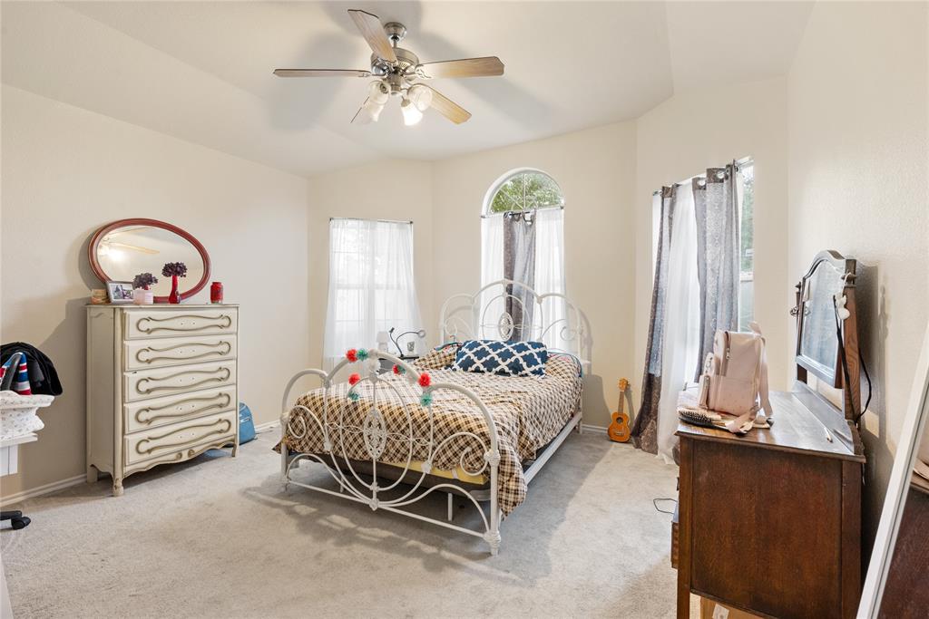 8613 King Ranch Drive Cross Roads, TX 76227 - Photo 18 of 25 a bedroom with furniture and a chandelier