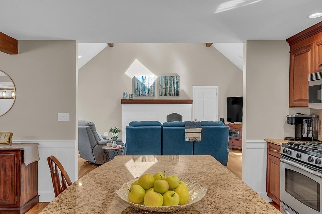 27 Sable Run Lane Methuen, MA 01844 - Photo 12 of 42 a living room with furniture a fireplace and a flat screen tv