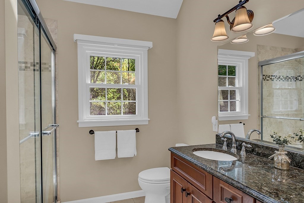 27 Sable Run Lane Methuen, MA 01844 - Photo 23 of 42 a bathroom with a granite countertop sink a toilet a mirror and window