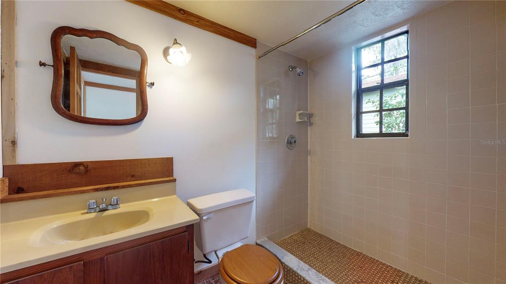 19803 Reading Road Lutz, FL 33558 - Photo 45 of 48 a bathroom with a sink toilet a mirror and tub