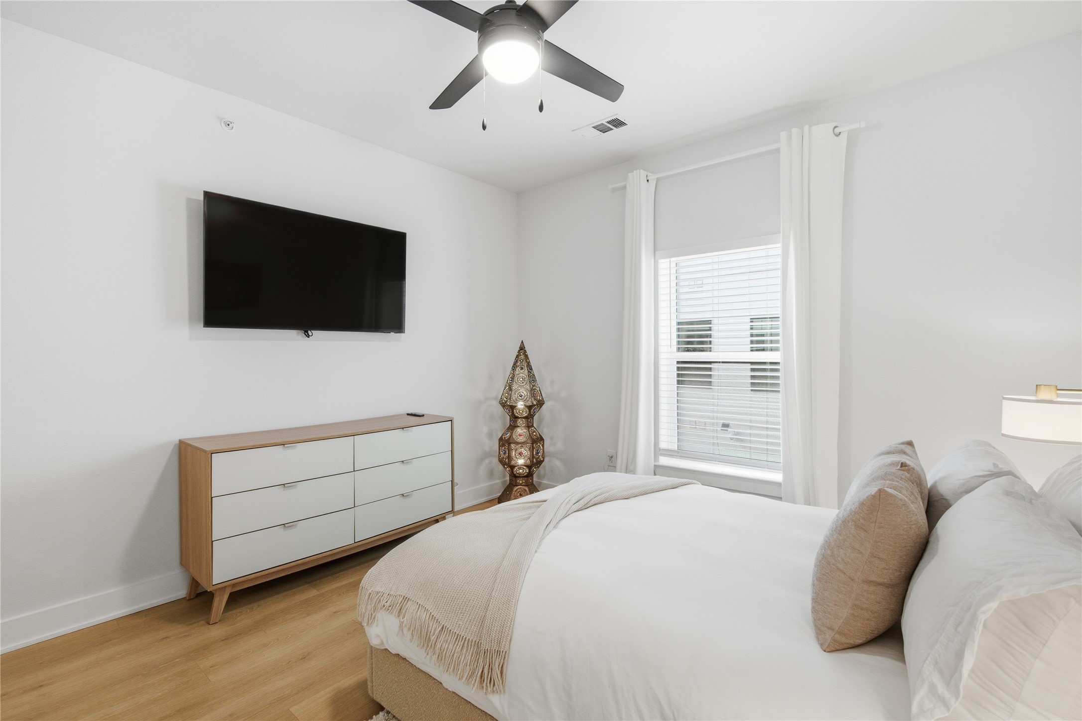 2500 Longview Street, Unit 219 Austin, TX 78705 - Photo 11 of 40 Bedroom with wood finished floors and ceiling fan