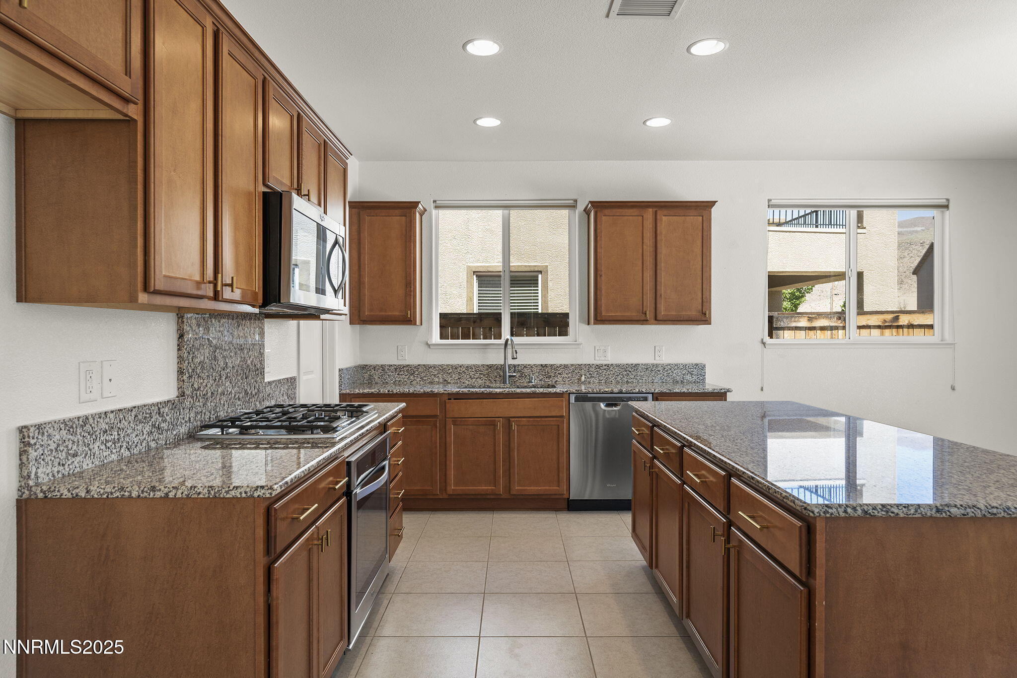 9610 Eventer Lane Reno, NV 89521 - Photo 11 of 38 a kitchen with granite countertop cabinets stainless steel appliances a sink and a window