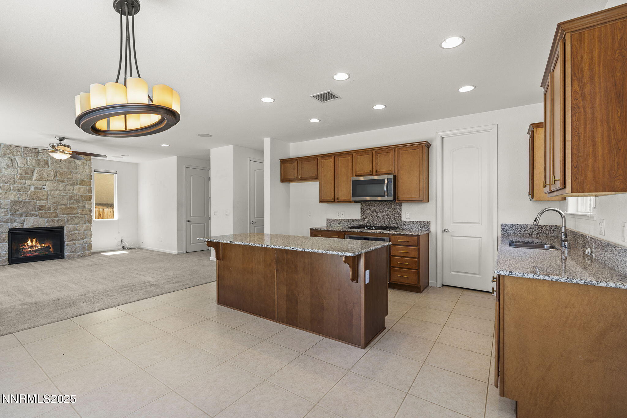 9610 Eventer Lane Reno, NV 89521 - Photo 12 of 38 a kitchen with stainless steel appliances granite countertop a sink a stove top oven a counter space and cabinets