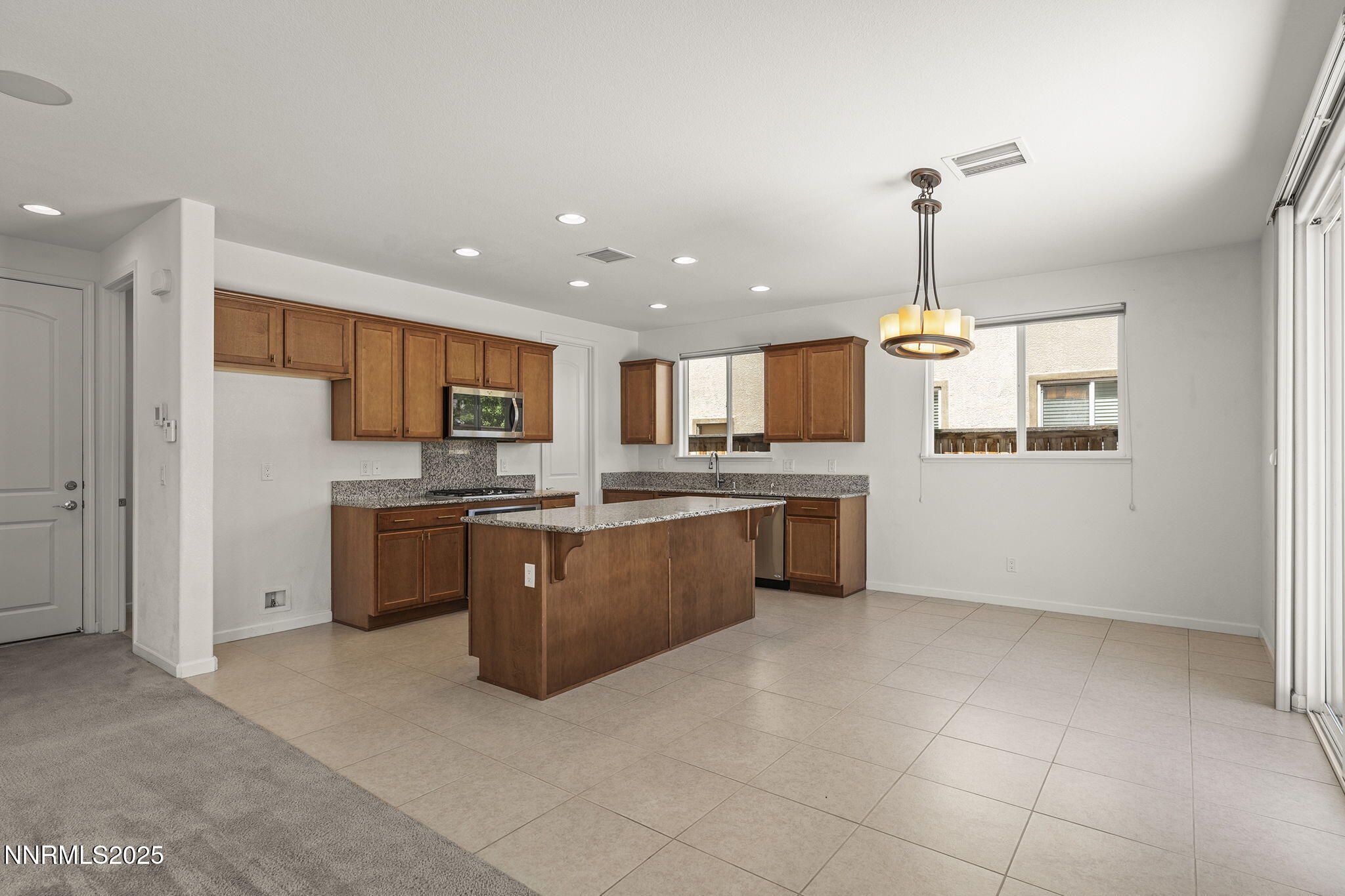 9610 Eventer Lane Reno, NV 89521 - Photo 13 of 38 a large kitchen with a large counter top appliances and cabinets