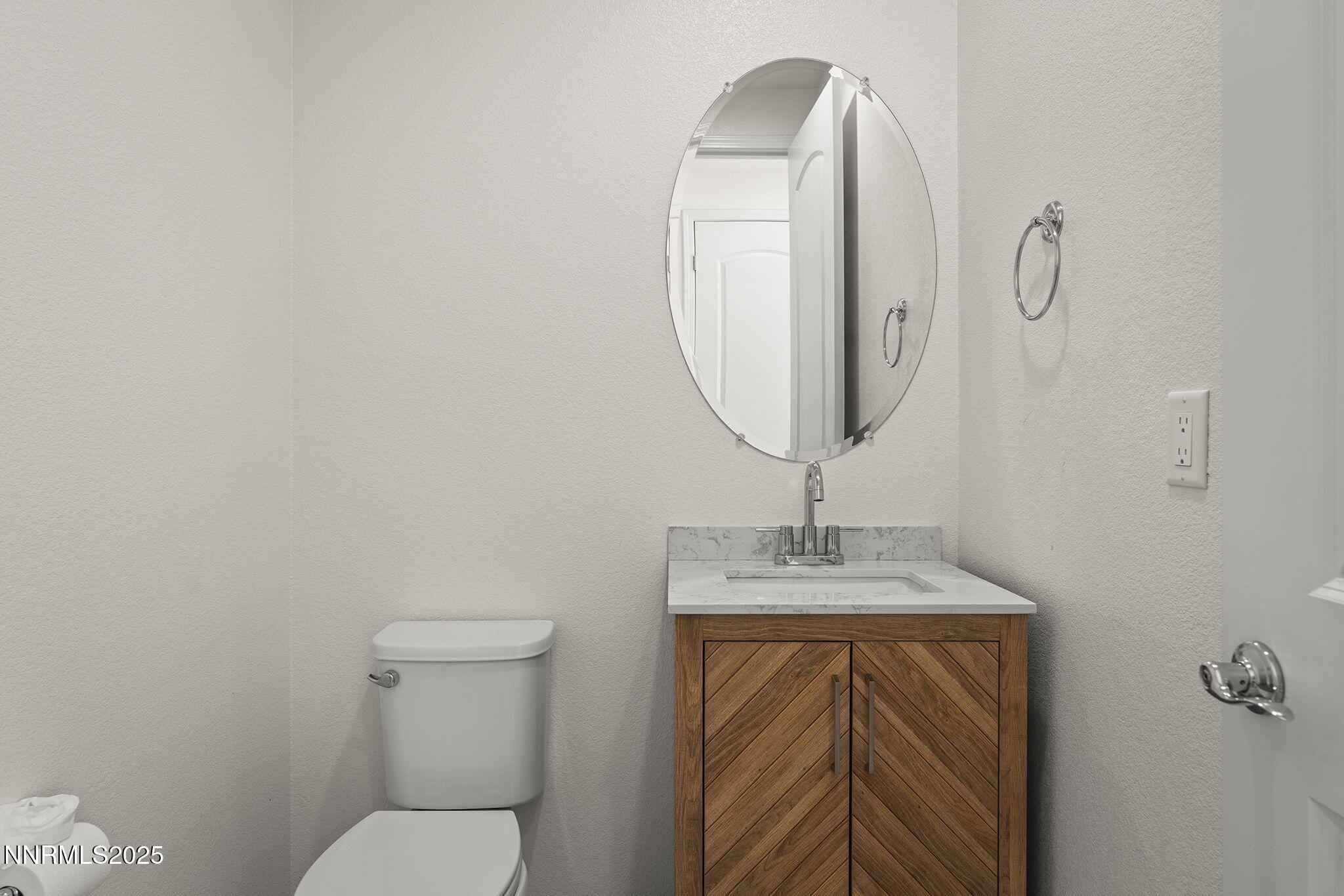 9610 Eventer Lane Reno, NV 89521 - Photo 15 of 38 a bathroom with a toilet a sink and mirror