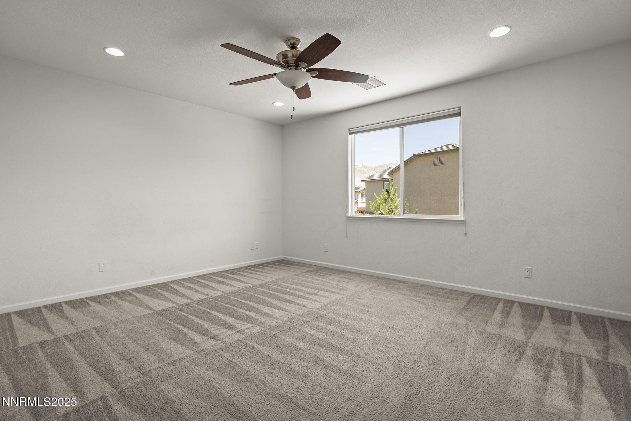9610 Eventer Lane Reno, NV 89521 - Photo 16 of 38 an empty room with a window and a ceiling fan