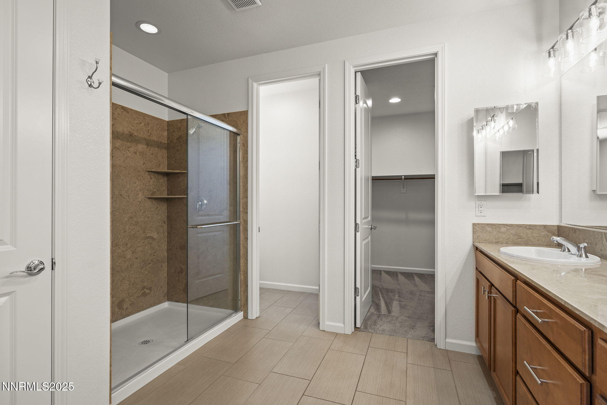 9610 Eventer Lane Reno, NV 89521 - Photo 17 of 38 a bathroom with a shower sink and mirror