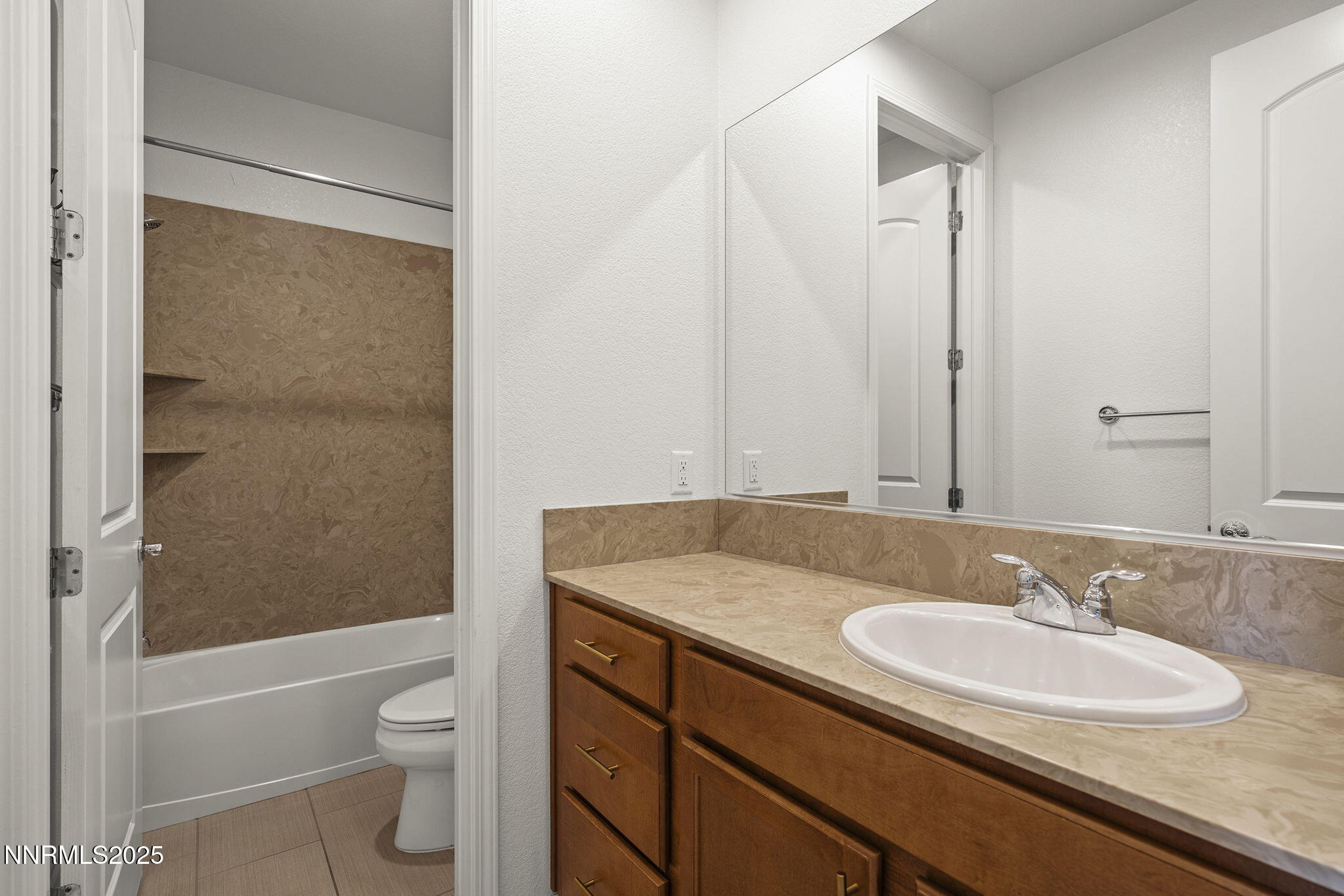 9610 Eventer Lane Reno, NV 89521 - Photo 20 of 38 a bathroom with a granite countertop sink toilet and shower
