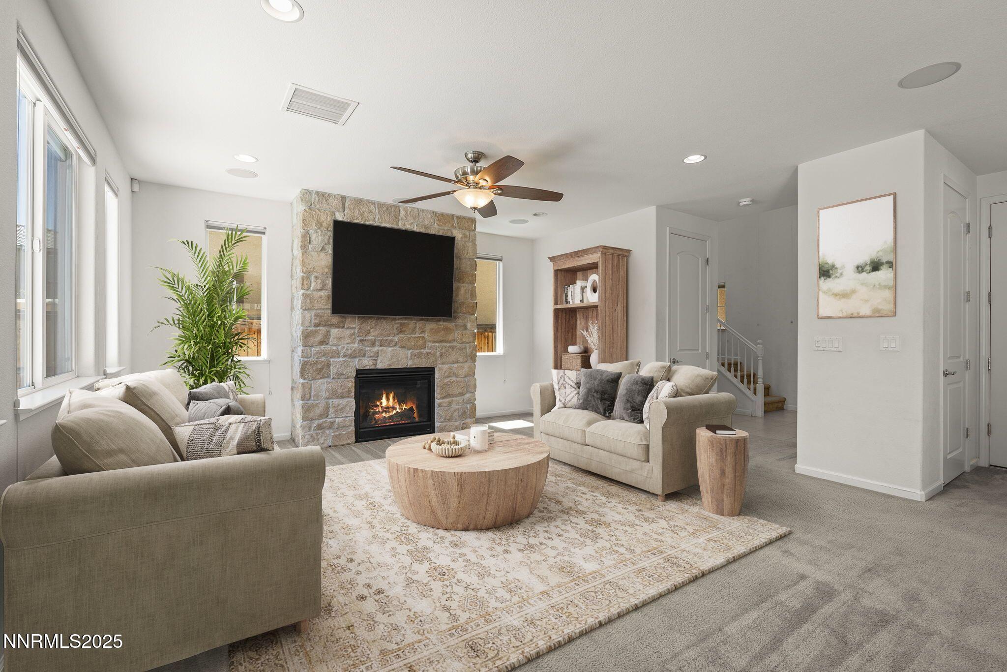 9610 Eventer Lane Reno, NV 89521 - Photo 3 of 38 a living room with furniture a flat screen tv and a fireplace