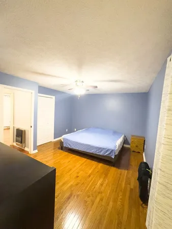 a bedroom with a bed and a dresser