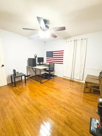 a view of a room with furniture and wooden floor