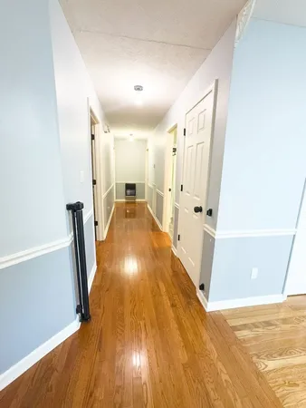 a view of empty room with wooden floor and fireplace
