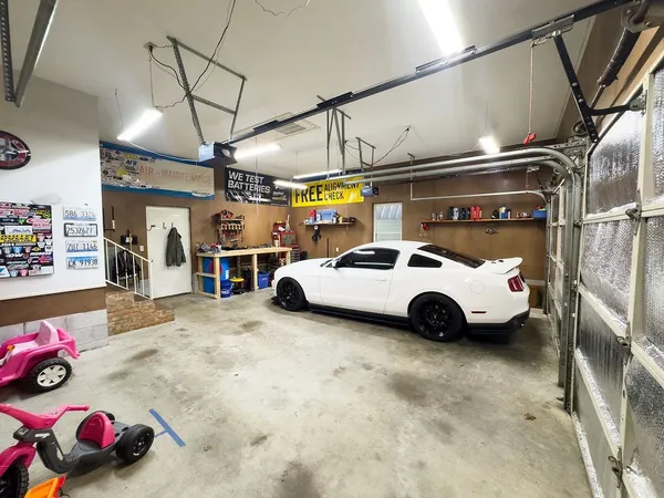 a view of parking garage with cars parked