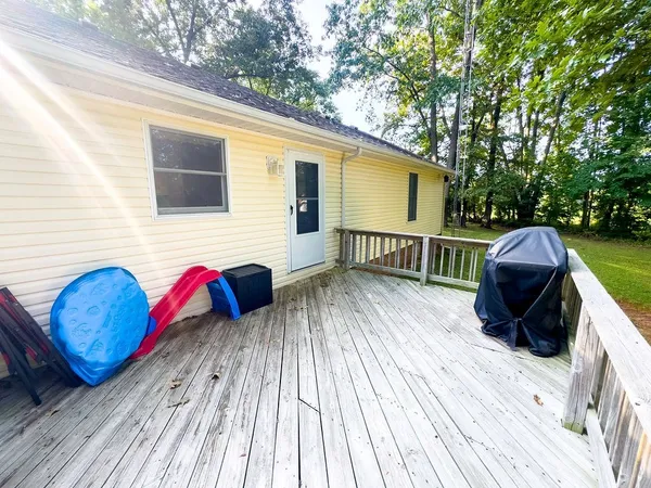 a view of a backyard with wooden fence
