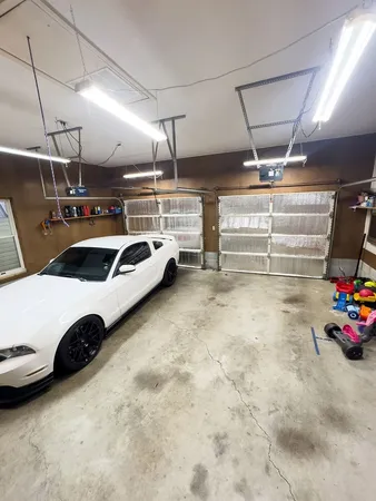 a kitchen with a refrigerator and white cabinets