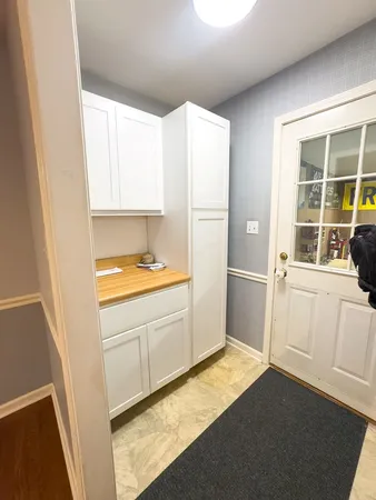 a view of a dining room with furniture a chandelier and wooden floor