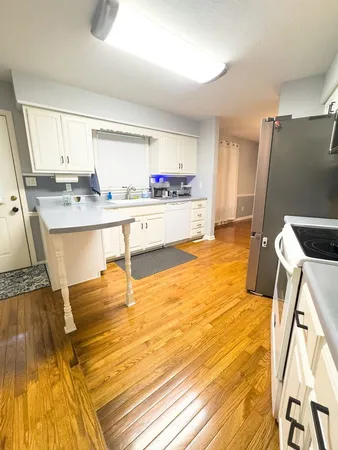 a kitchen with stainless steel appliances a sink a stove and a refrigerator