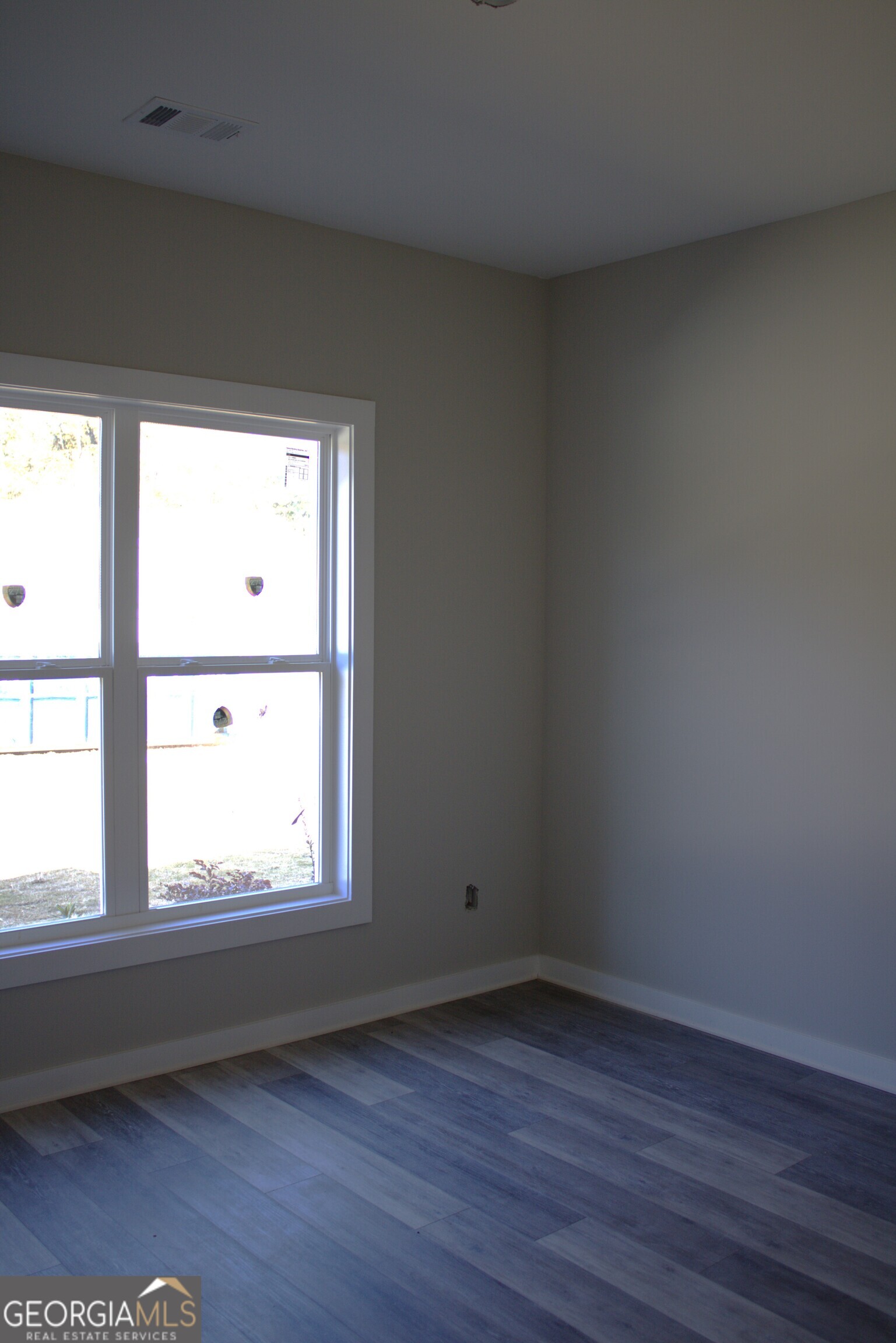 123 Fairview Street Hartwell, GA 30643 - Photo 17 of 23 an empty room with wooden floor and windows