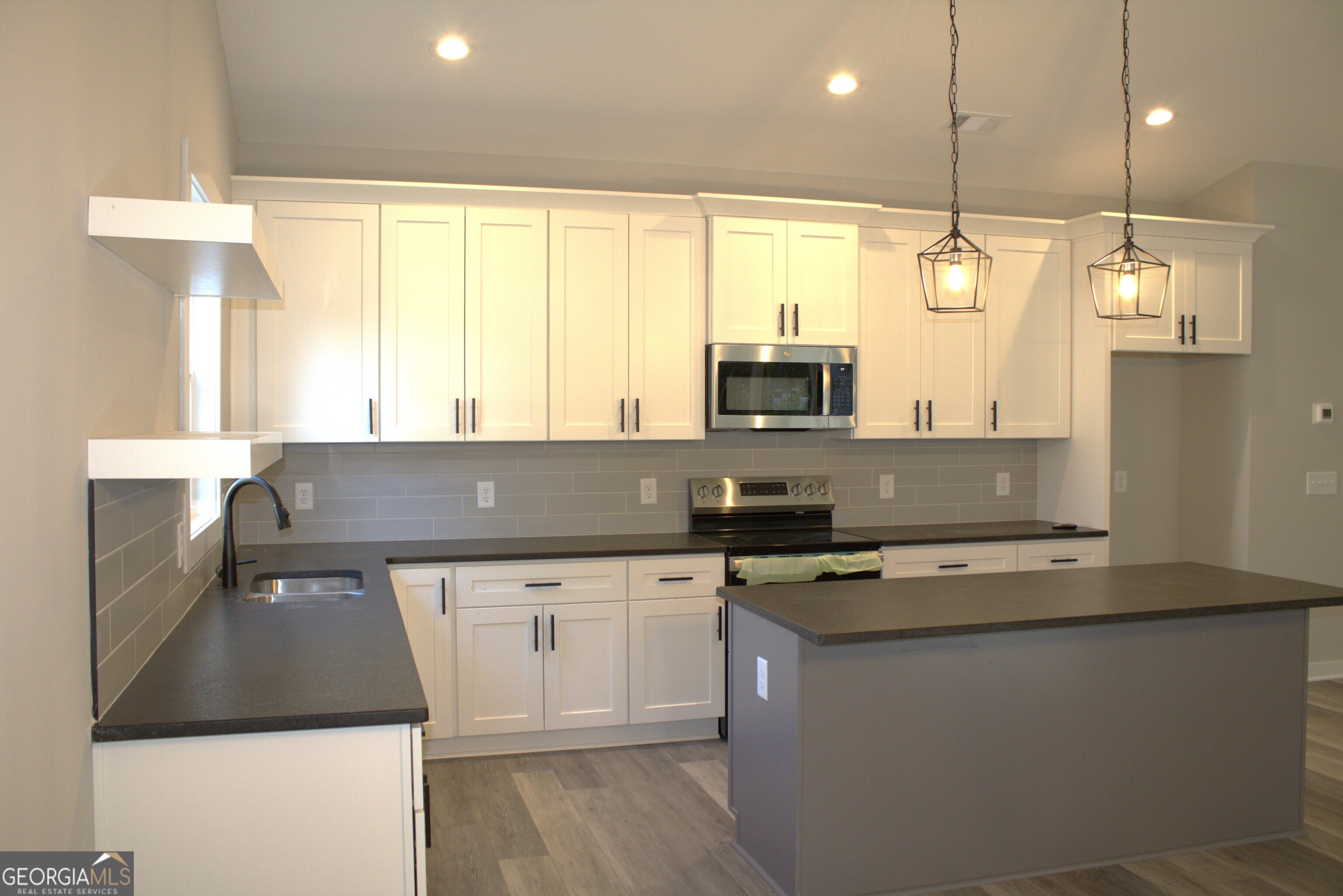 123 Fairview Street Hartwell, GA 30643 - Photo 9 of 23 a kitchen with a sink a window and stainless steel appliances