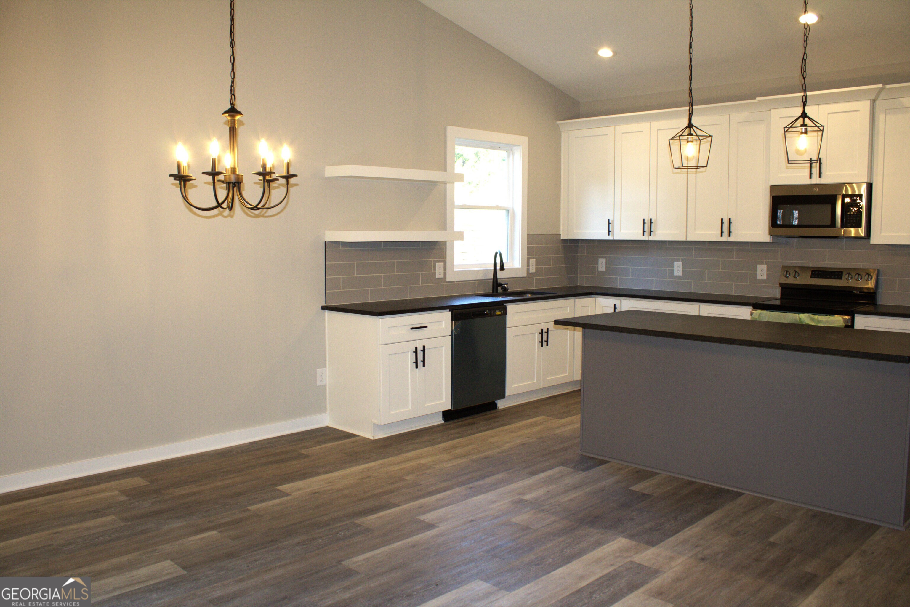 123 Fairview Street Hartwell, GA 30643 - Photo 10 of 23 a kitchen with stainless steel appliances granite countertop a sink a microwave oven a stove and a wooden floors