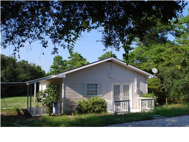 a view of house with a yard