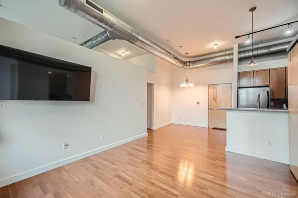 a view of a room with wooden floor and windows