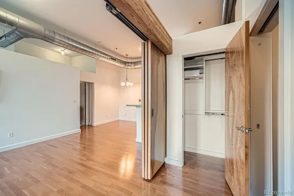 a kitchen with a sink cabinets and wooden floor