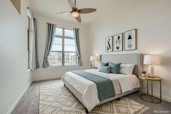 a bedroom with a large bed and a window