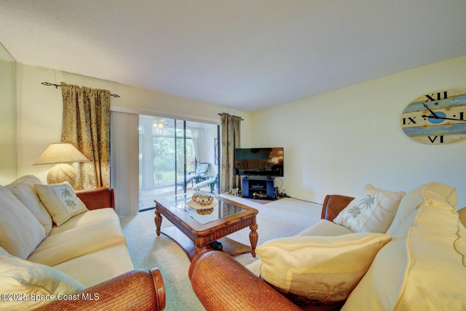 227 Augusta Way Melbourne, FL 32940 - Photo 17 of 35 a living room with furniture and a flat screen tv