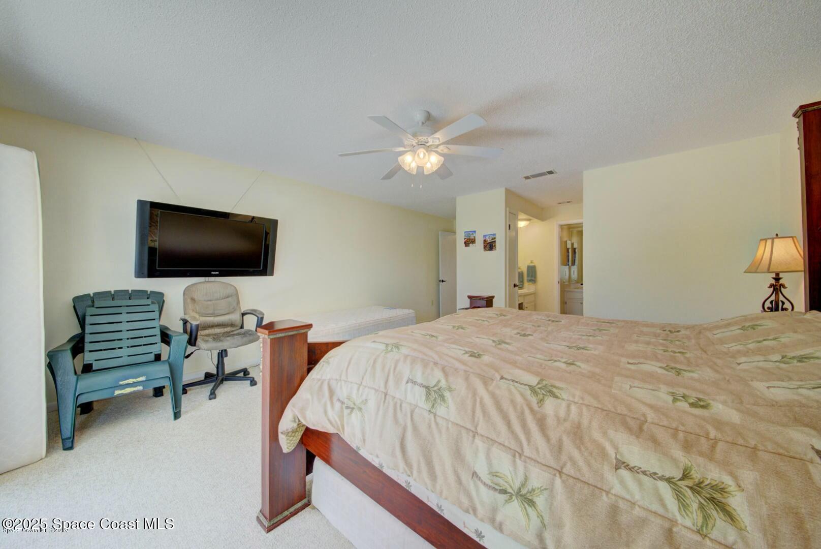 227 Augusta Way Melbourne, FL 32940 - Photo 22 of 35 a bedroom with a bed and a flat screen tv