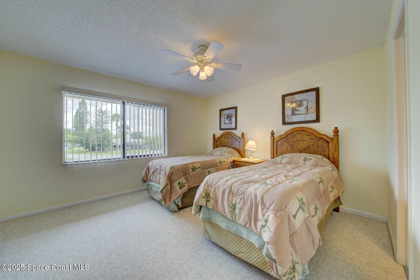 227 Augusta Way Melbourne, FL 32940 - Photo 25 of 35 a spacious bedroom with two beds and a window