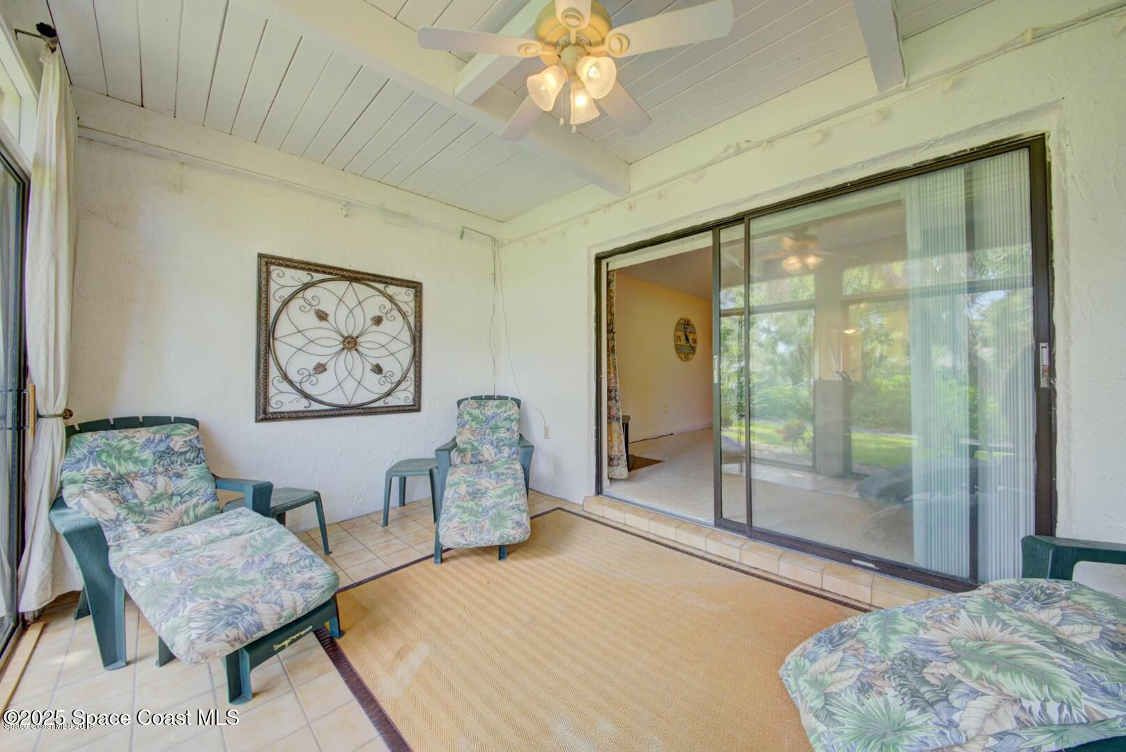 227 Augusta Way Melbourne, FL 32940 - Photo 31 of 35 a bedroom with a bed and glass window