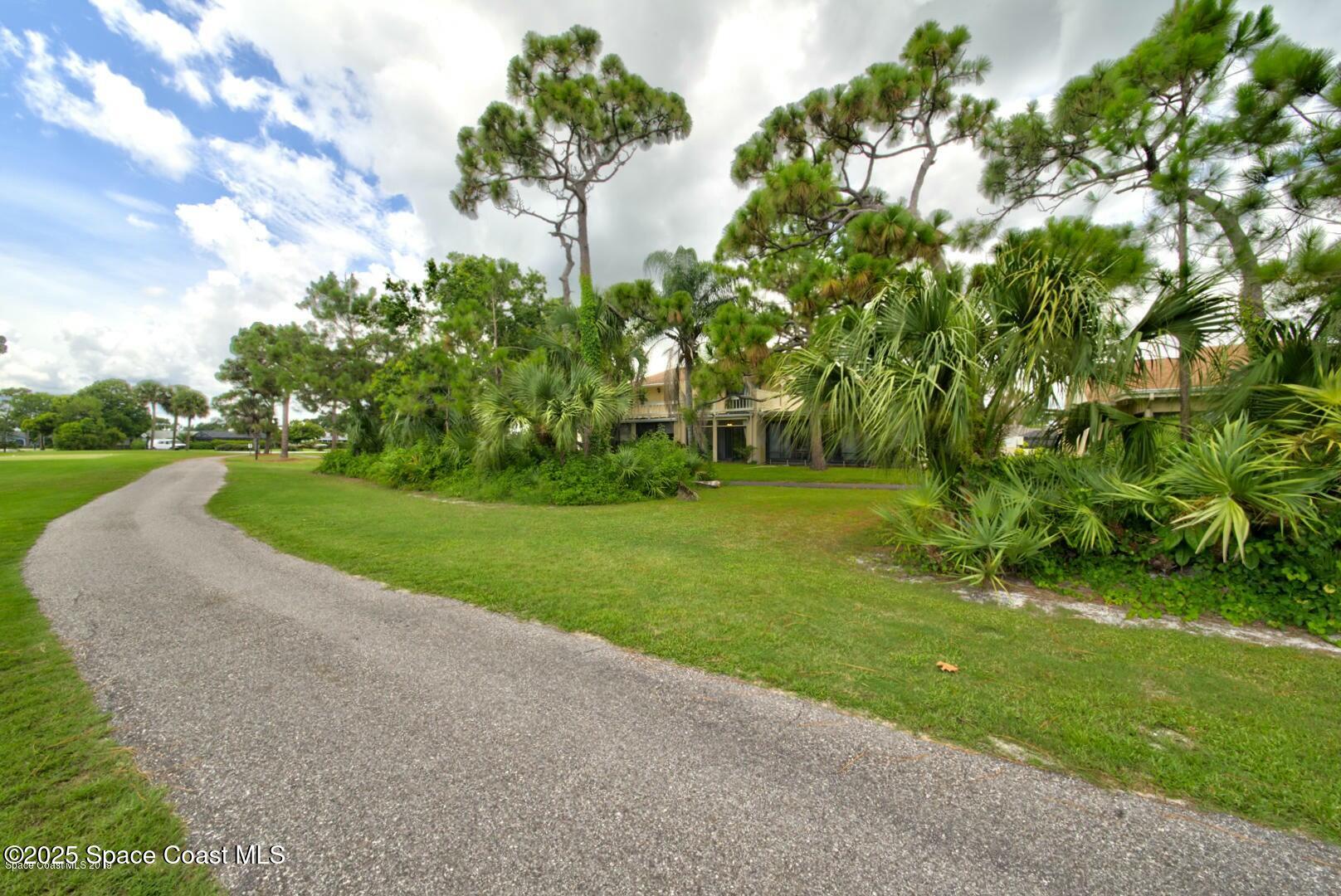 227 Augusta Way Melbourne, FL 32940 - Photo 34 of 35 a view of a garden with a fountain