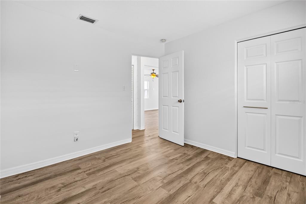 13440 1st Street East Madeira Beach, FL 33708 - Photo 39 of 44 a view of an empty room with wooden floor and closet
