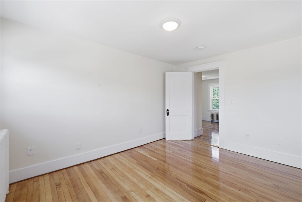 17 Rollinson Road Worcester, MA 01606 - Photo 25 of 41 a view of an empty room with wooden floor and a window