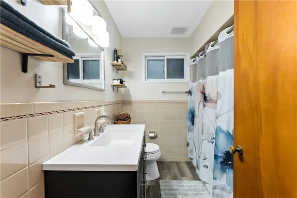 a bathroom with a sink toilet and shower