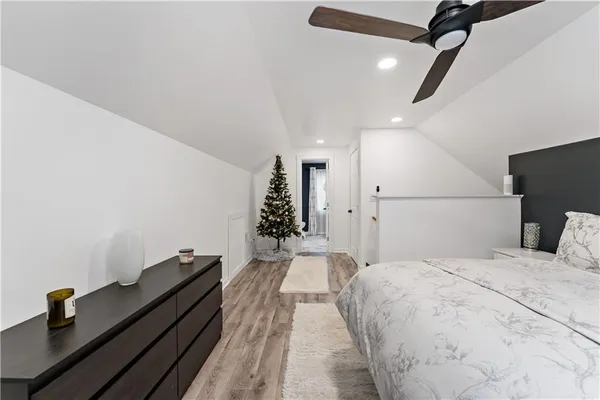 a bed room with a bed and a ceiling fan