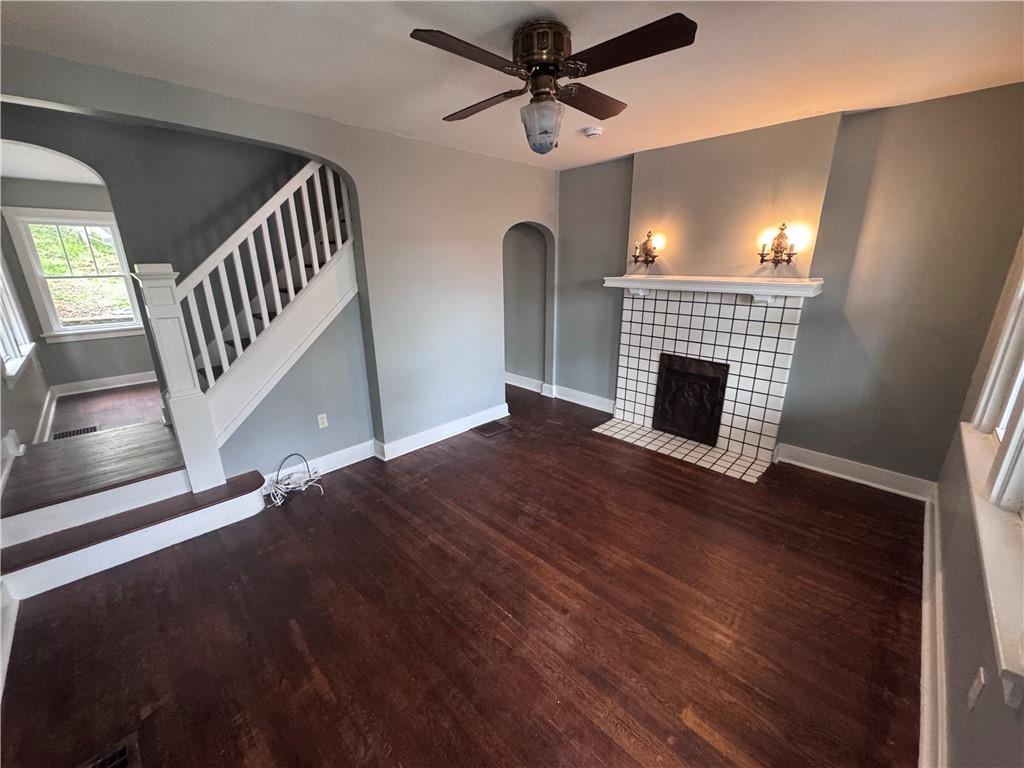 2733 Pyramid Avenue Pittsburgh, PA 15227 - Photo 4 of 14 a view of an empty room with wooden floor fireplace and a window