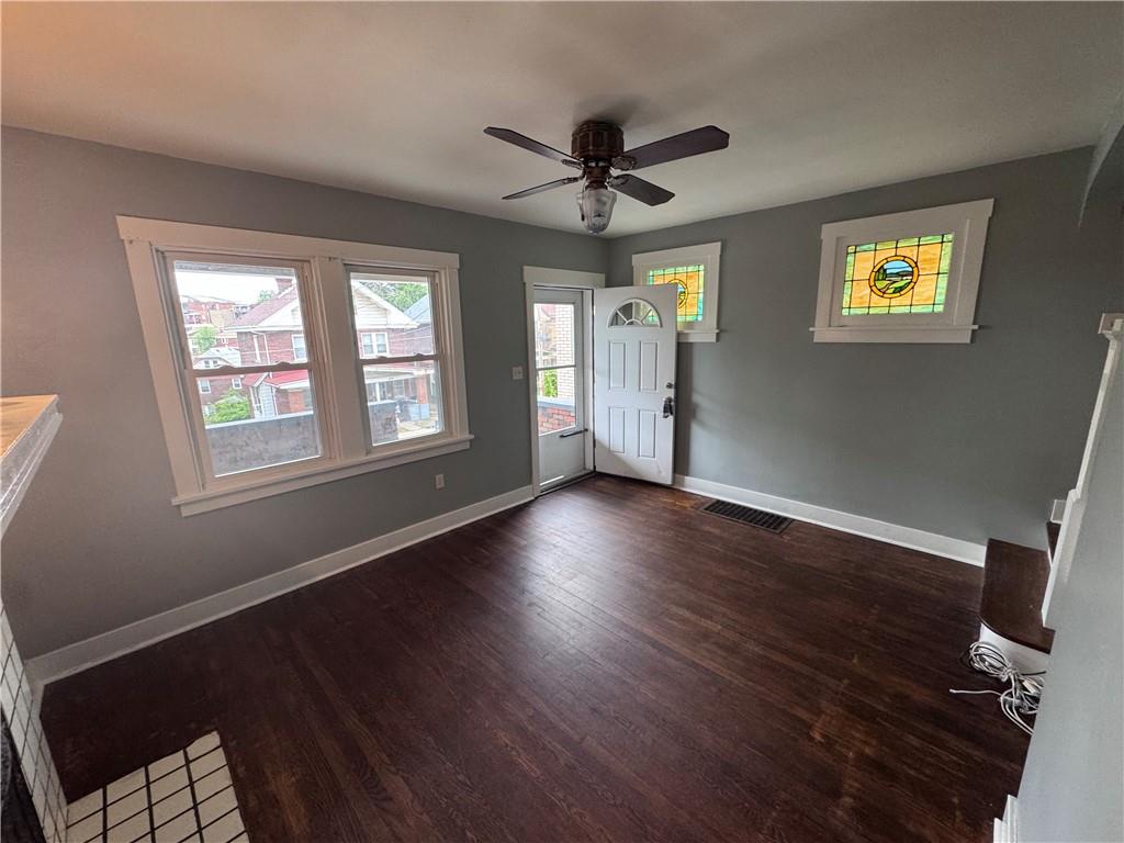 2733 Pyramid Avenue Pittsburgh, PA 15227 - Photo 5 of 14 a view of an empty room with a window and wooden floor