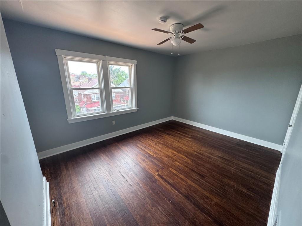 2733 Pyramid Avenue Pittsburgh, PA 15227 - Photo 9 of 14 a view of an empty room with wooden floor and a window