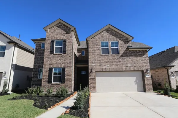 a front view of a house with garage