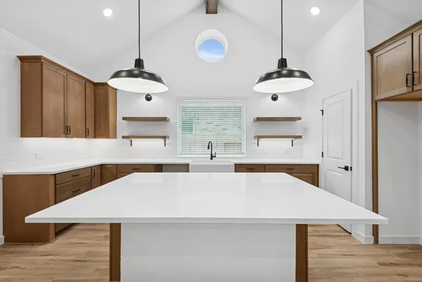 a large kitchen with stainless steel appliances a large counter space a sink and appliances