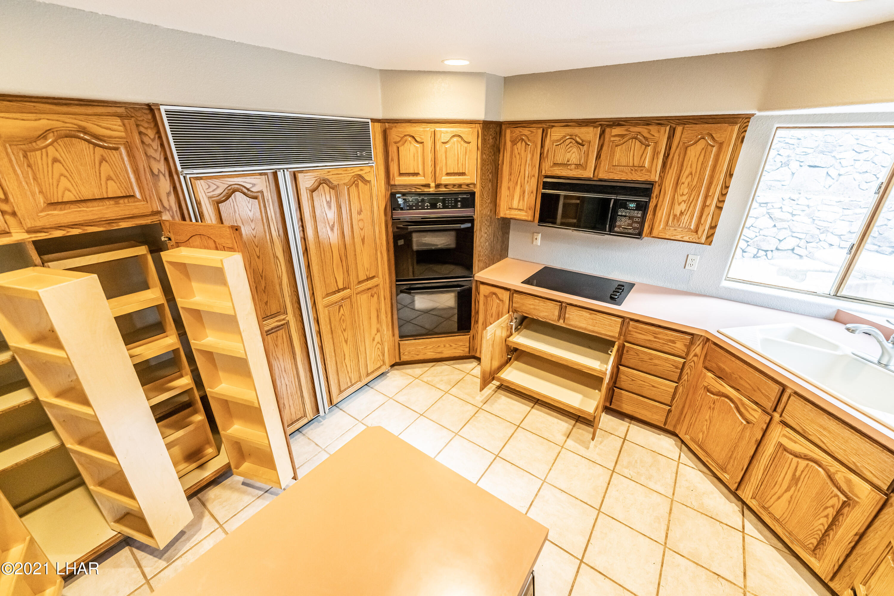 4740 South Ridge Road Kingman, AZ 86401 - Photo 13 of 82 Look at that pantry and the pull outs on the bottom cabinets