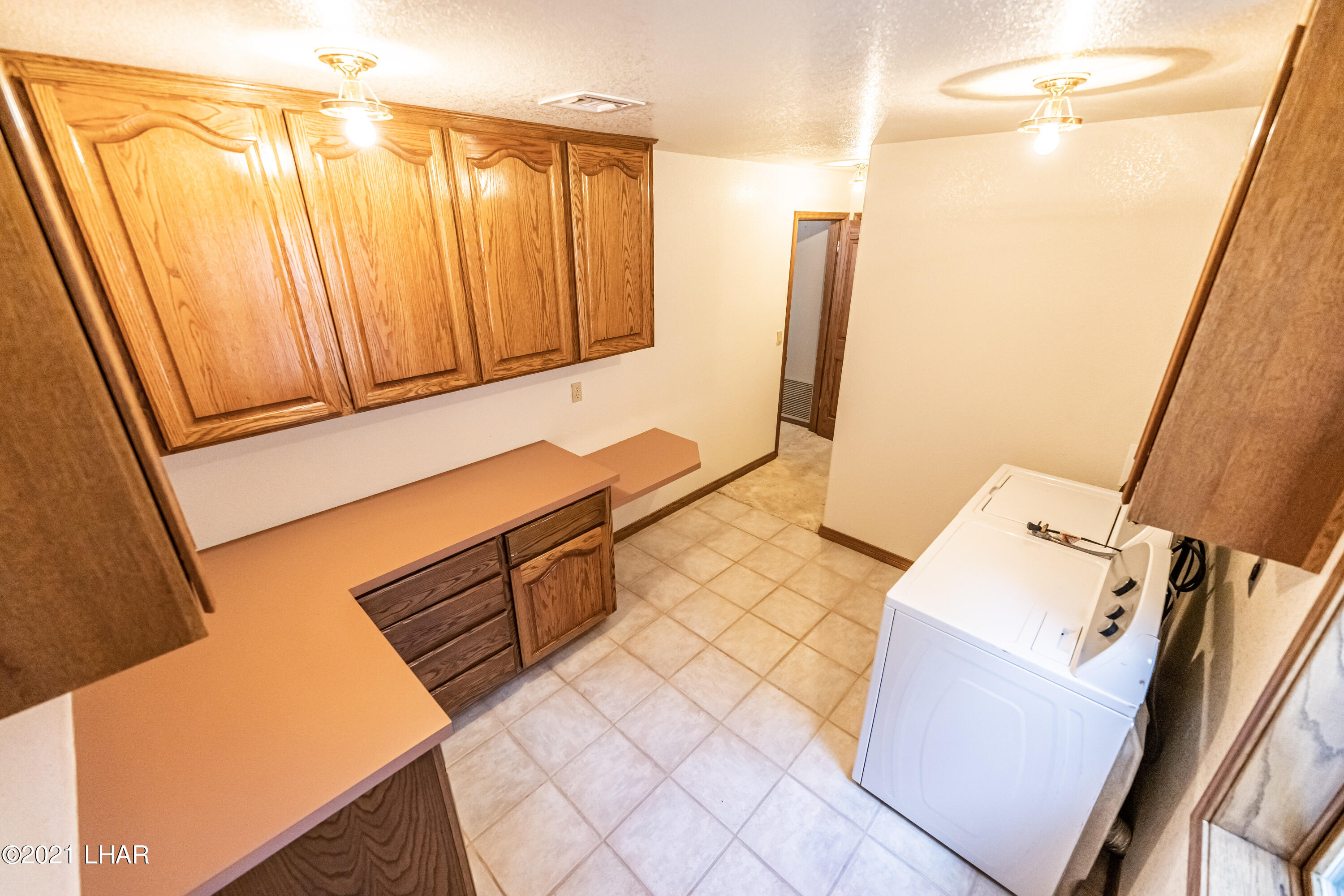 4740 South Ridge Road Kingman, AZ 86401 - Photo 27 of 82 Laundry Room inside home with door outside.
