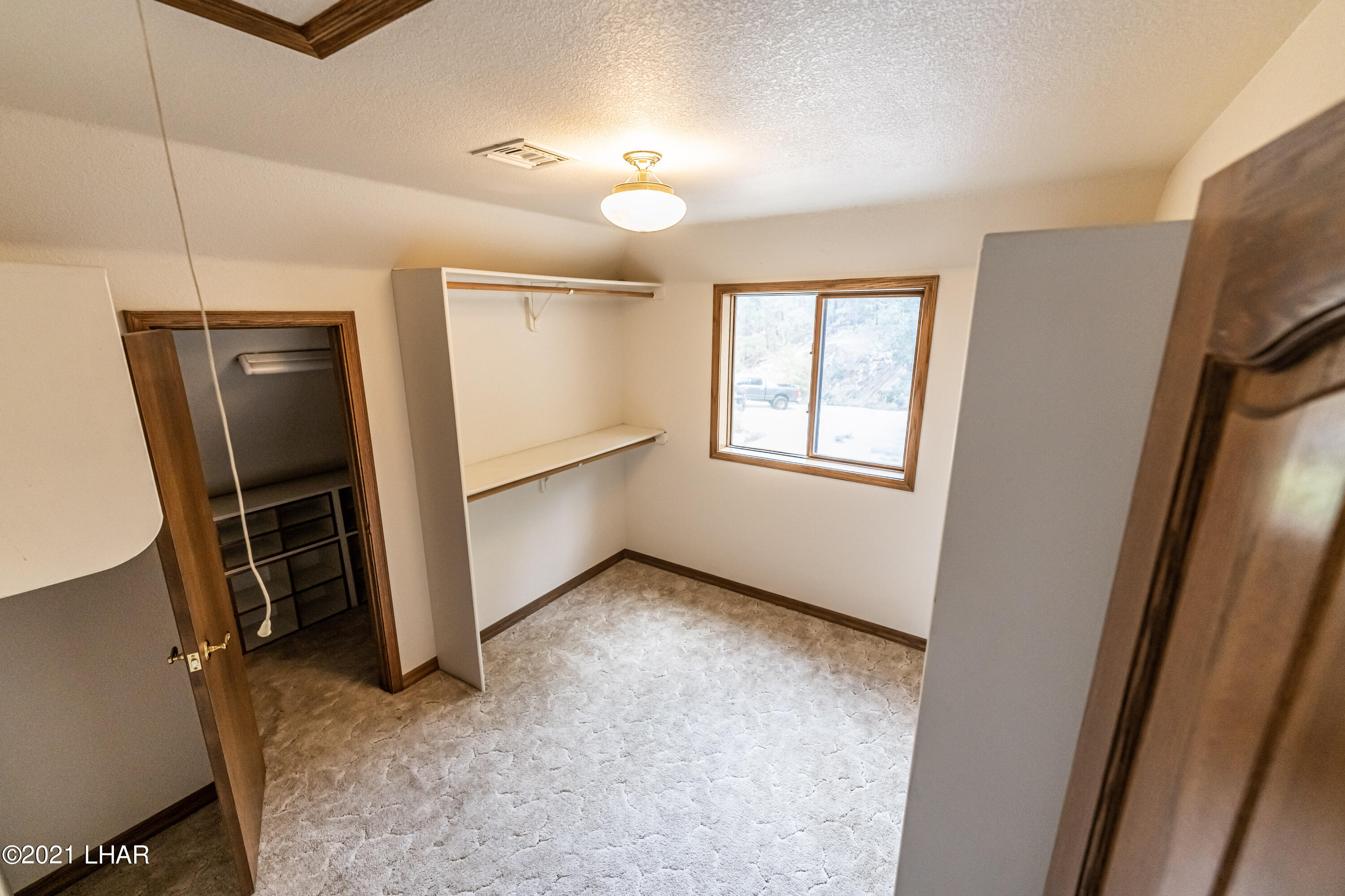 4740 South Ridge Road Kingman, AZ 86401 - Photo 38 of 82 Master 1 closet with extra closet through door.