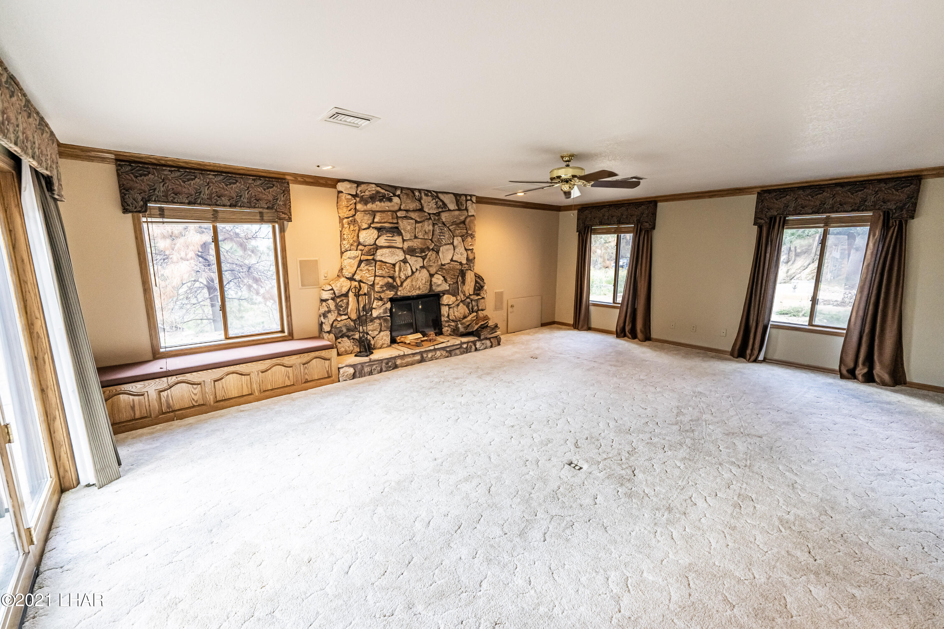 4740 South Ridge Road Kingman, AZ 86401 - Photo 7 of 82 Grand Living Room features rock fireplace.