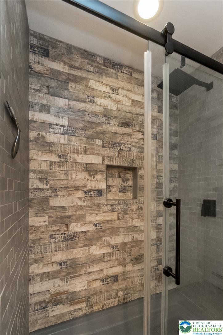 9461 Red Road Kempton, PA 19529 - Photo 28 of 55 A striking shower design with rustic wood-look tile and modern glass enclosure.